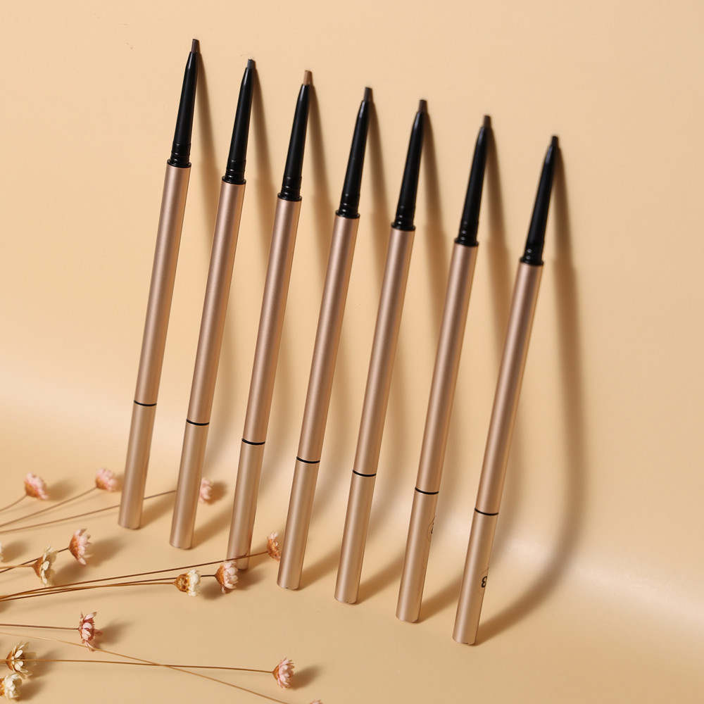 Seven gold brow pencils arranged in a row